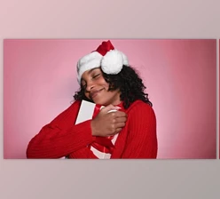 Download Happy Woman in Santa Hat Holding Present Merry Christmas Concept (Videohive 47712440)